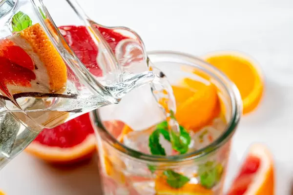 From the pitcher pouring lemonade into a glass