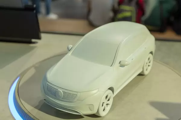 Front view of model car Mercedes EQC 400 on illuminated exhibition platform at IAA