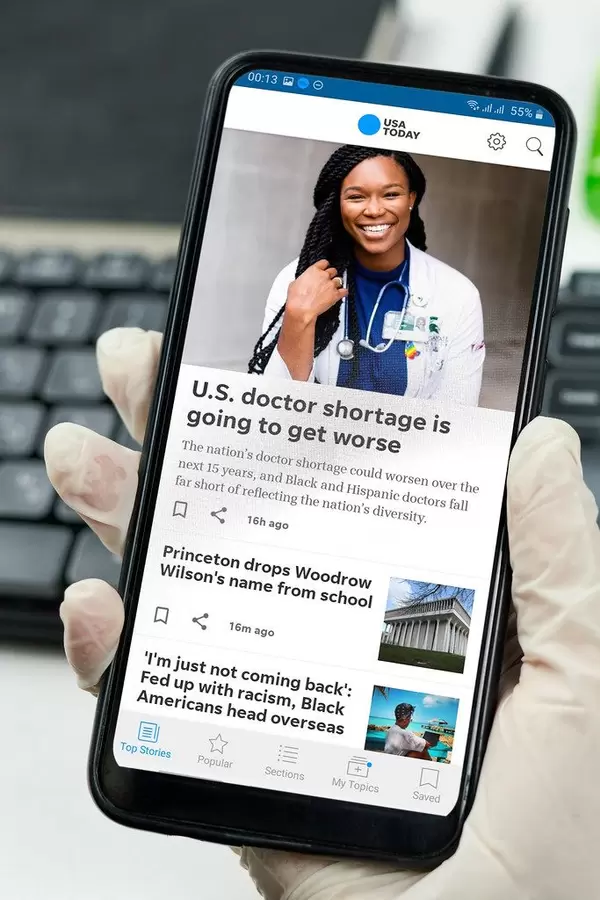 Frontline healthcare worker checking news via smartphone.jpg