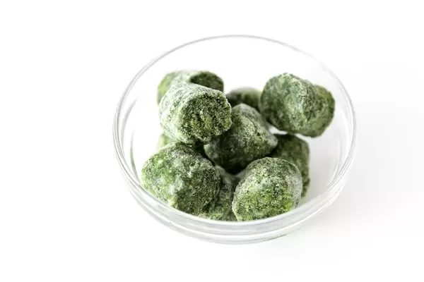 Frozen spinach in a glass bowl