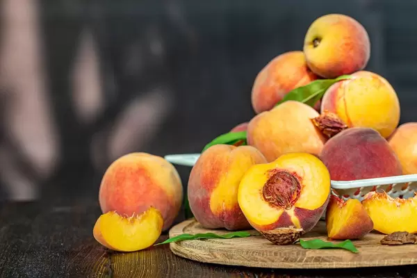 Fruit background with fresh ripe peaches