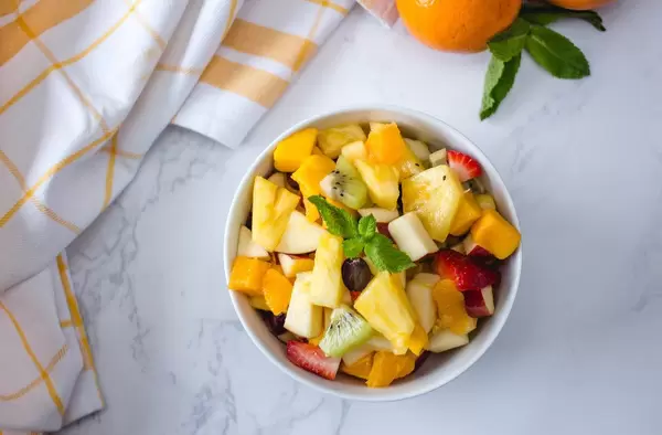 Fruit Salad With Ananas, kiwi, Apples, Strawberries, Orange and Mango Top View