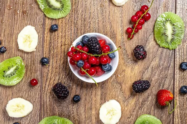 Fruit summer background with berries, kiwi slices and banana (Flip 2019)