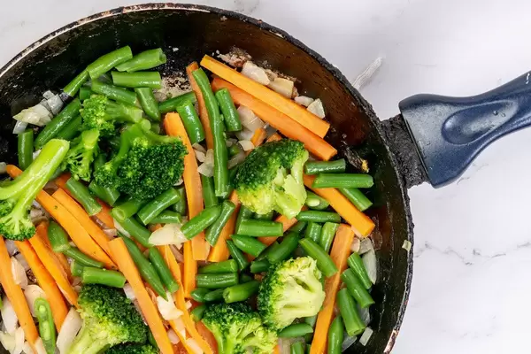 Frying Carrot with Green Beans Onions and Broccoli