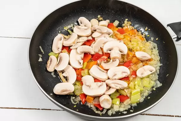 Frying fresh Onions Paprika and Mushrooms