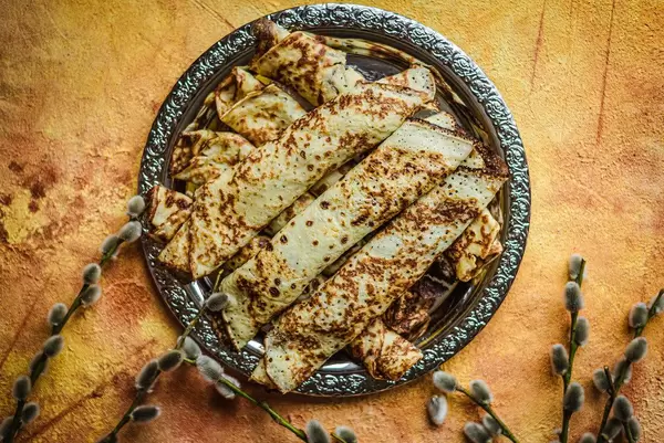 Frying Pancakes With Chocolate Filling On Orange Background (1).jpg