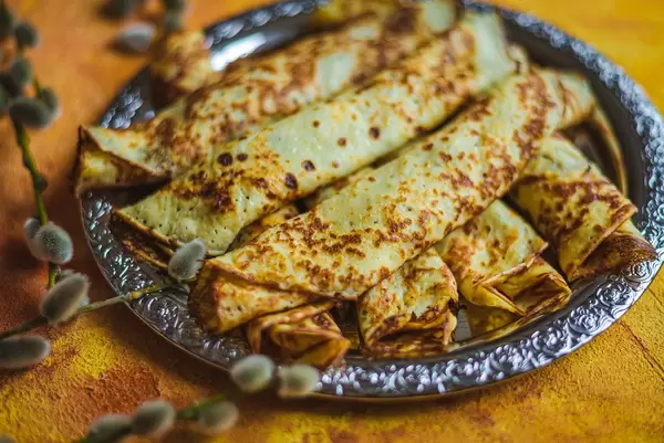 Frying Pancakes With Chocolate Filling On Orange Background Close Up (Flip 2020)