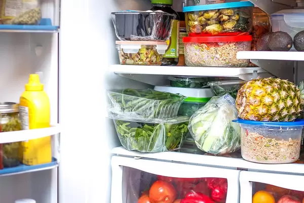 Fully stacked fridge with healthy food fruits and vegetables