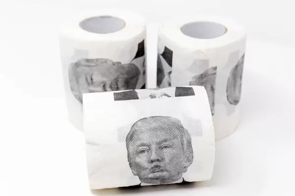 Fun with politics: three rolls of toilet paper with a print of Donald Trump's facial expressions