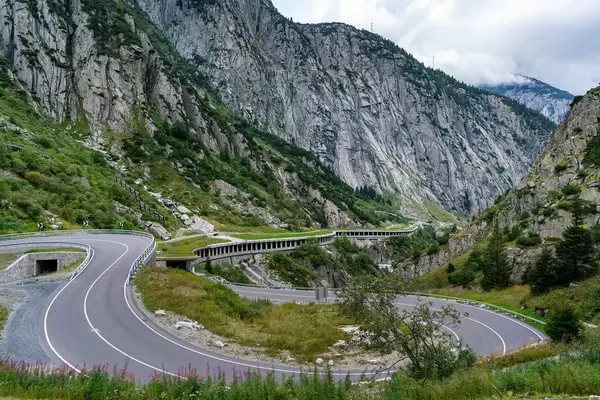 Furkapass serpentine road disappearing into the epic column tunnel