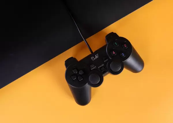 Gamepad with a cord on a orange and black background