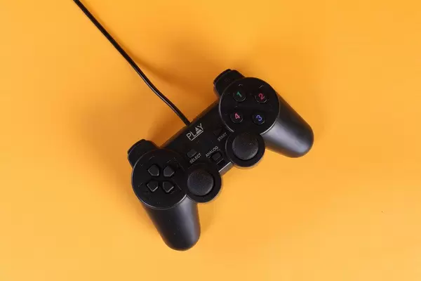 Gamepad with a cord on a orange background