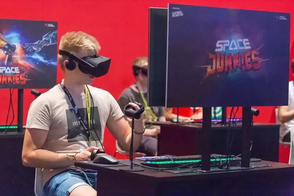 Gamer playing Space Junkies with VR headset and controller