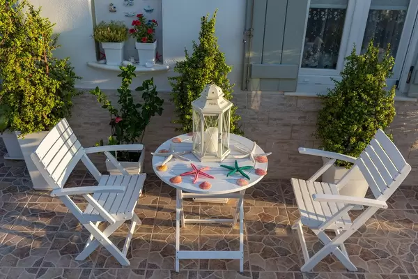 Garden furniture decorated with colorful starfish, on the terrace of a Greek dwelling house in the Cycladic city Naousa