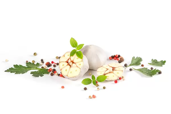 Garlic, dill leaves, parsley, basil and peppers on white