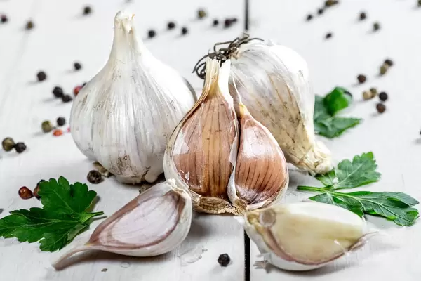 garlic, parsley and pepper on white wooden background  Flip 2019