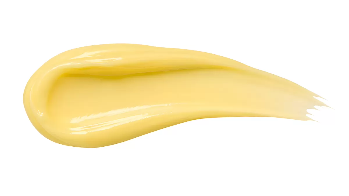 Gelber Cremestrich auf weißem Hintergrund