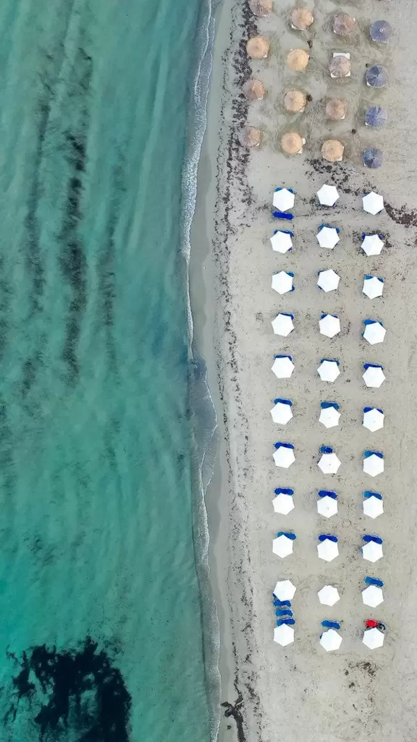 Geometric beach design: overhead drone shot at Agios Georgios (St. George) on Greek island Naxos