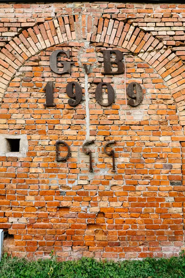 German GvB metal logo on a yellow brick wall