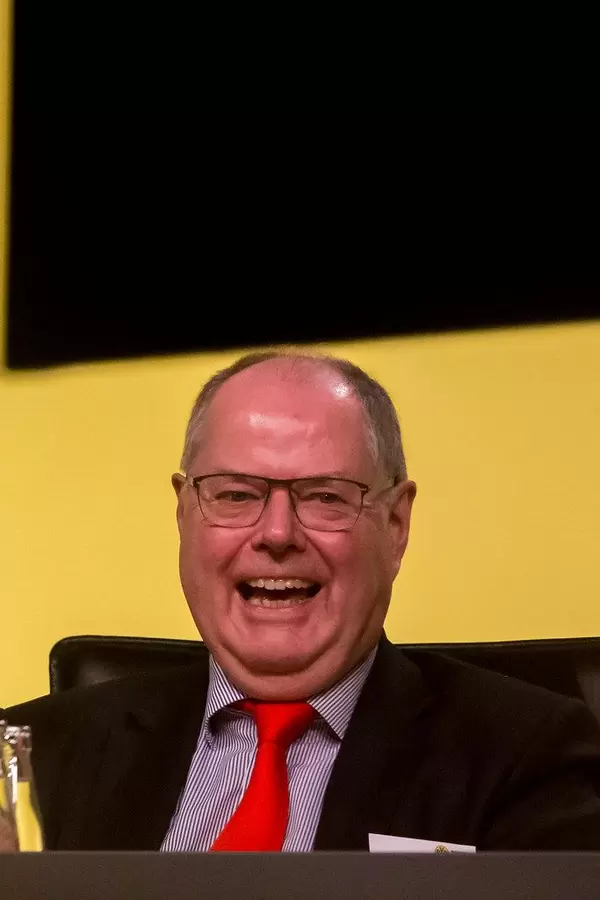 German social democratic politician Peer Steinbrück laughs during shareholders' meeting of German soccer club BVB