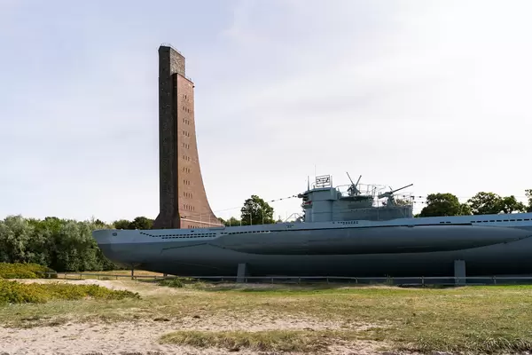 German Submarine on the shore in front of the tall brick Naval war Memorial