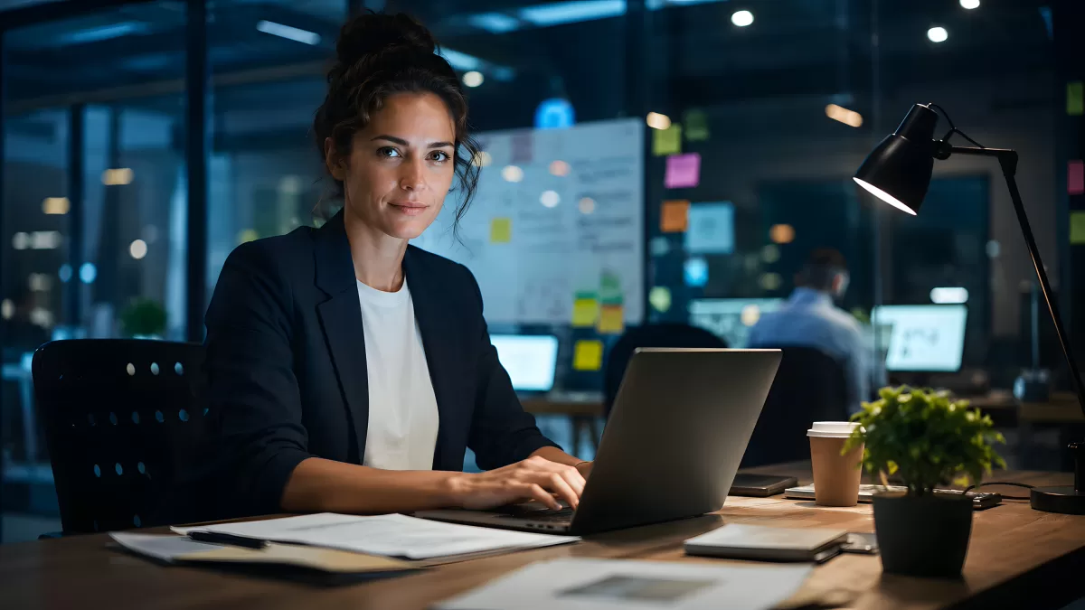 Geschäftsfrau arbeitet nachts im Büro am Laptop