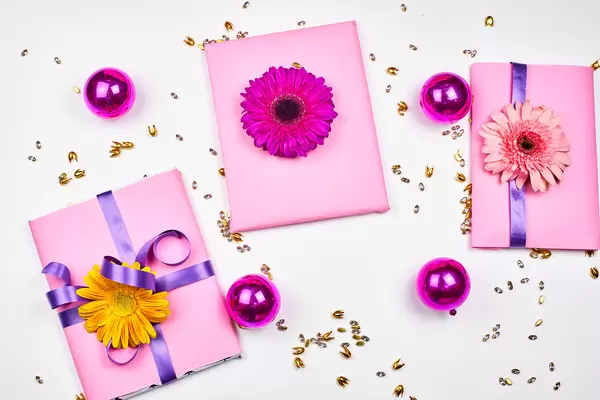 Gifts and flowers on white