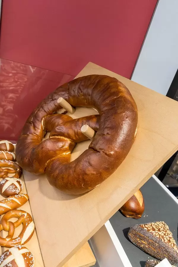 Gigantic Pretzel hangs on a wooden board and anuga food fair in Germany