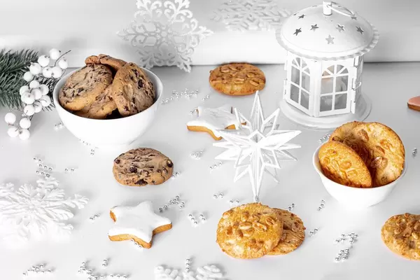 Ginger, chocolate and peanut cookies on a light Christmas background