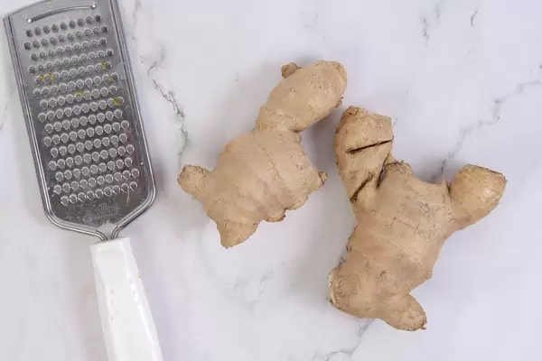 Ginger with Grater on the grey marble table