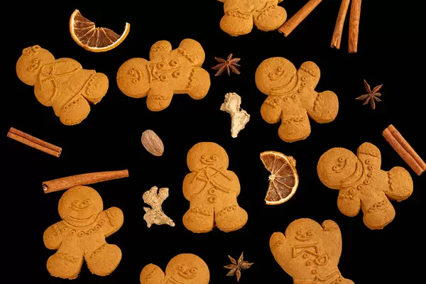 Gingerbread men with new year spices on black