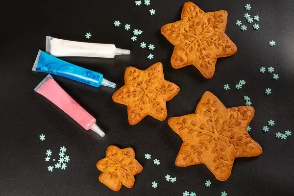 Gingerbread snowflakes with glaze of different colors