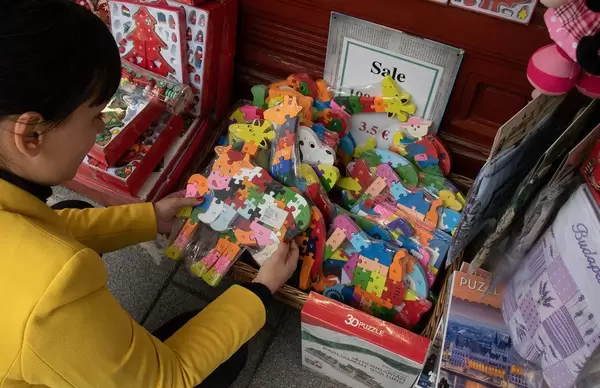 Girl buying gifts at souvenir shop in Budapest