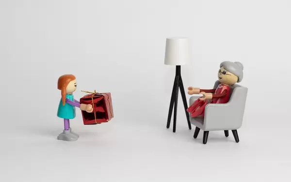 Girl giving present to grandmother