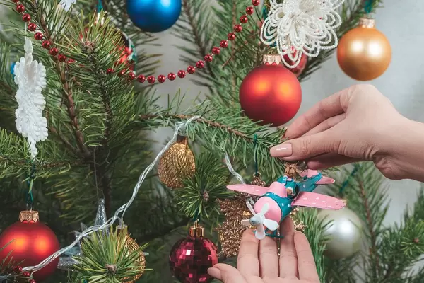 Girl hangs a plane with a deer on a Christmas tree (Flip 2019)