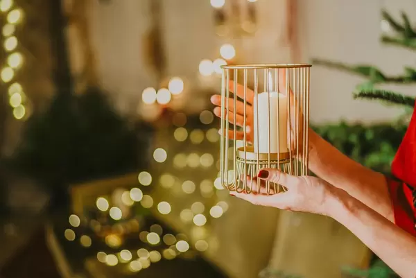 Girl Holding Candle On Christmas Lights
