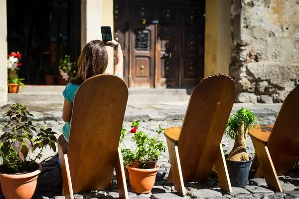Girl taking a selfie on wooden chairs  Flip 2019
