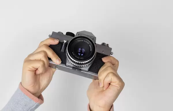Girl with vintage camera in the hands