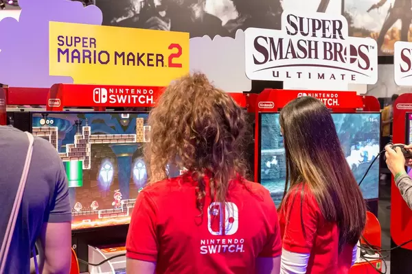 Girls at games fair Gamescom 2019 in Germany testing Super Mario Maker 2 on Nintendo Switch