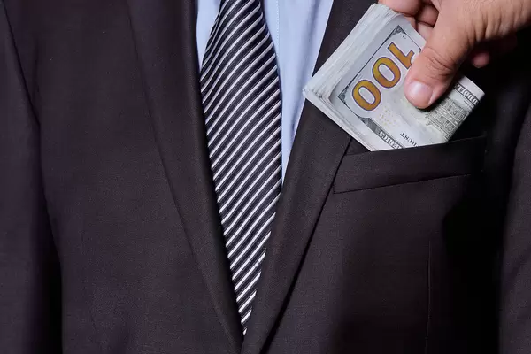 Giving a bribe into a pocket