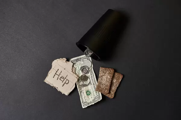 Giving money to beggar or homeless - poverty and social issue concept