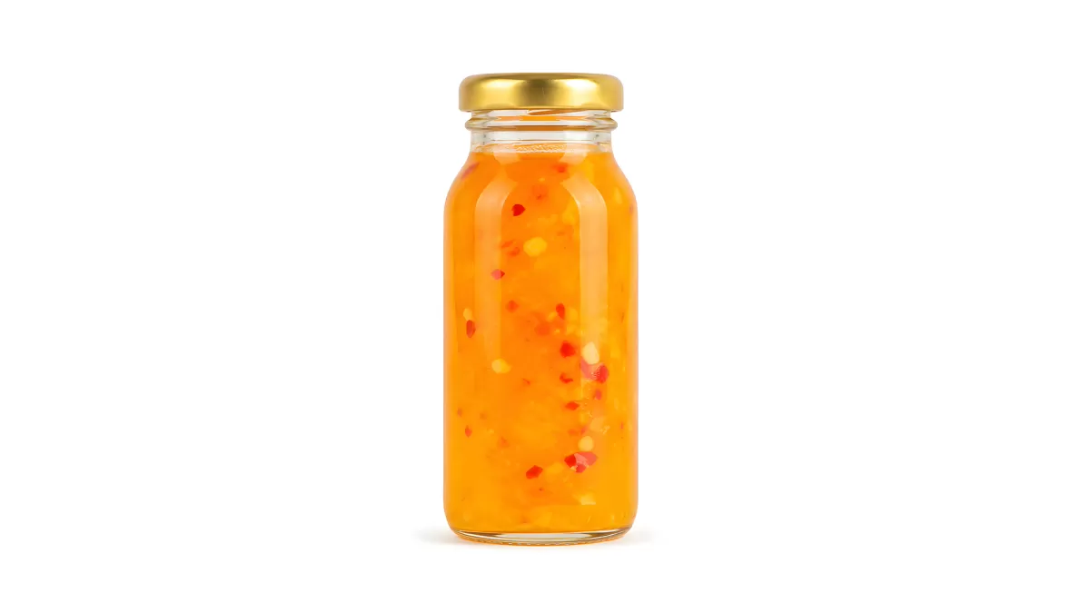 Glasfläschchen mit orangefarbener Chilisauce