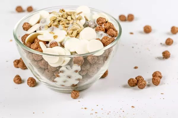 Glass bowl with corn balls, chocolate and yogurt