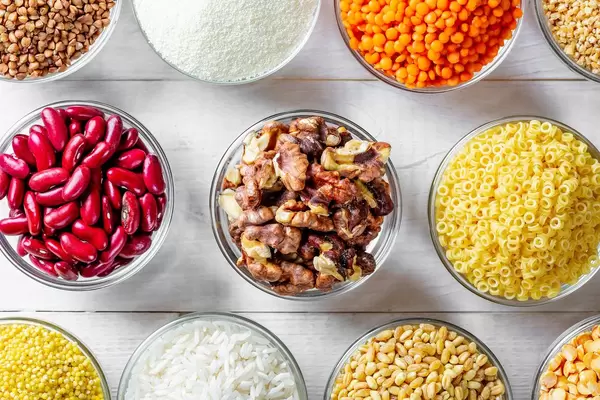Glass bowls with buckwheat, rice, lentils, wheat, beans, seeds and nuts
