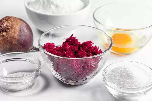 Glass bowls with ingredients for beetroot pancakes