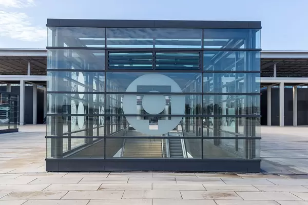Glass-covered escalators and stairs at Willy-Brandt-Platz in front of Terminal 1 at BER airport