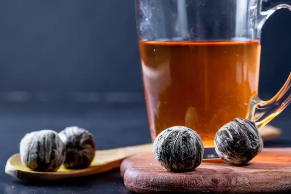 Glass Cup with tea and dried large flower buds