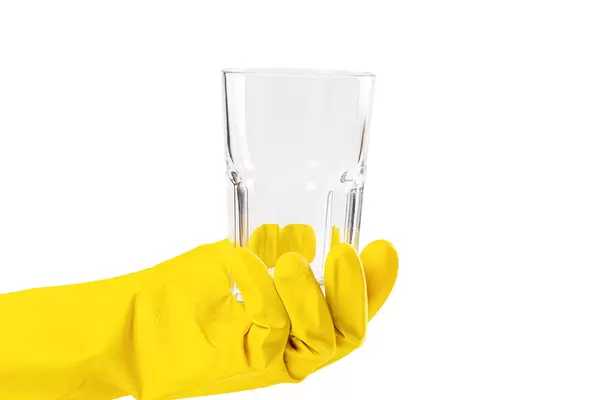 Glass in hand on white, dishwashing concept