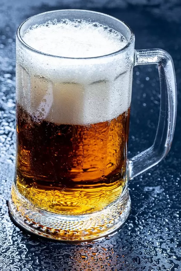 Glass of fresh beer with foam