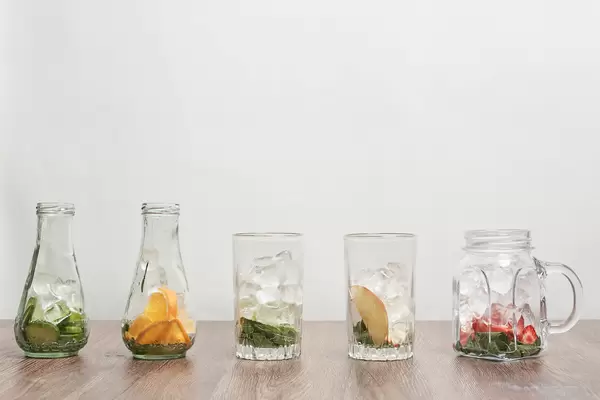 Glasses with different fruits and ingredients for making refreshing cool summer drinks